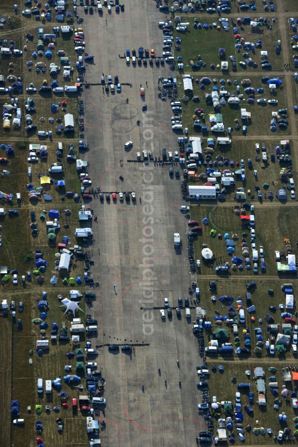 JÜTERBOG from above - Views of visitors to the Motorcycle Jamboree Festival on the disused runway of the airfield Altes Lager in Jueterbog in the state of Brandenburg. The Motorcycle Jamboree is aimed primarily at motorcycle enthusiasts. It play music live bands in the style of Rock, Hard Rock, Blues Rock, Heavy Metal and there is a program with bike shows, motorcycle games. http://