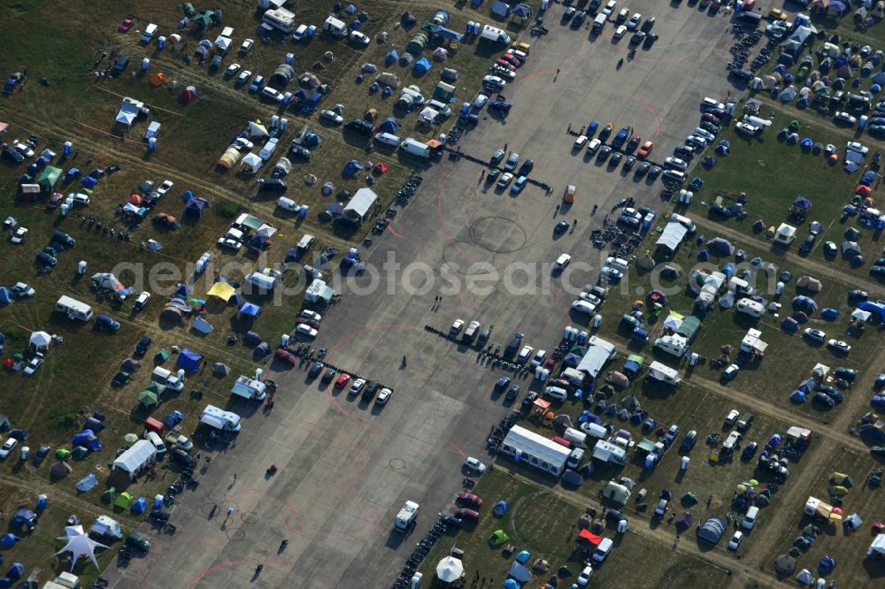 Aerial image JÜTERBOG - Views of visitors to the Motorcycle Jamboree Festival on the disused runway of the airfield Altes Lager in Jueterbog in the state of Brandenburg. The Motorcycle Jamboree is aimed primarily at motorcycle enthusiasts. It play music live bands in the style of Rock, Hard Rock, Blues Rock, Heavy Metal and there is a program with bike shows, motorcycle games. http://