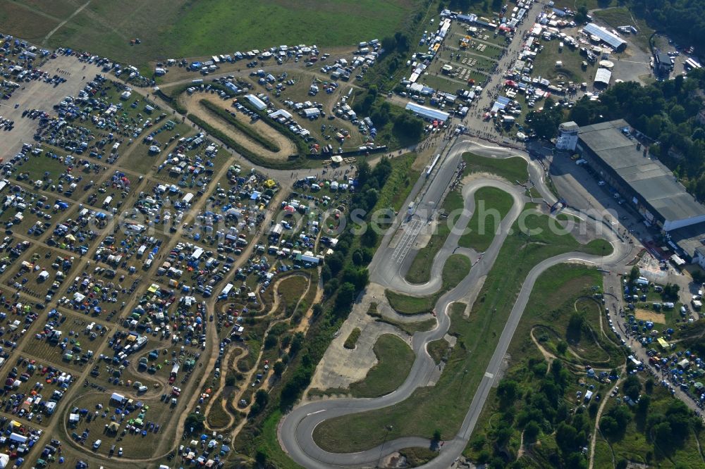 JÜTERBOG from above - Views of visitors to the Motorcycle Jamboree Festival on the disused runway of the airfield Altes Lager in Jueterbog in the state of Brandenburg. The Motorcycle Jamboree is aimed primarily at motorcycle enthusiasts. It play music live bands in the style of Rock, Hard Rock, Blues Rock, Heavy Metal and there is a program with bike shows, motorcycle games. http://