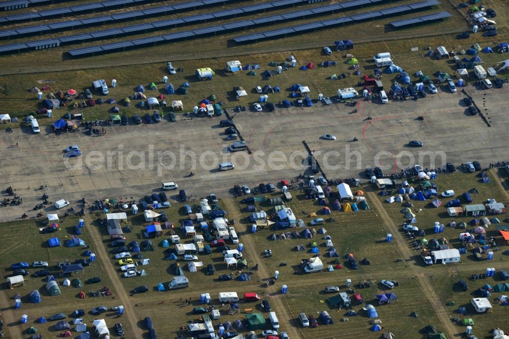 Aerial photograph JÜTERBOG - Views of visitors to the Motorcycle Jamboree Festival on the disused runway of the airfield Altes Lager in Jueterbog in the state of Brandenburg. The Motorcycle Jamboree is aimed primarily at motorcycle enthusiasts. It play music live bands in the style of Rock, Hard Rock, Blues Rock, Heavy Metal and there is a program with bike shows, motorcycle games. http://