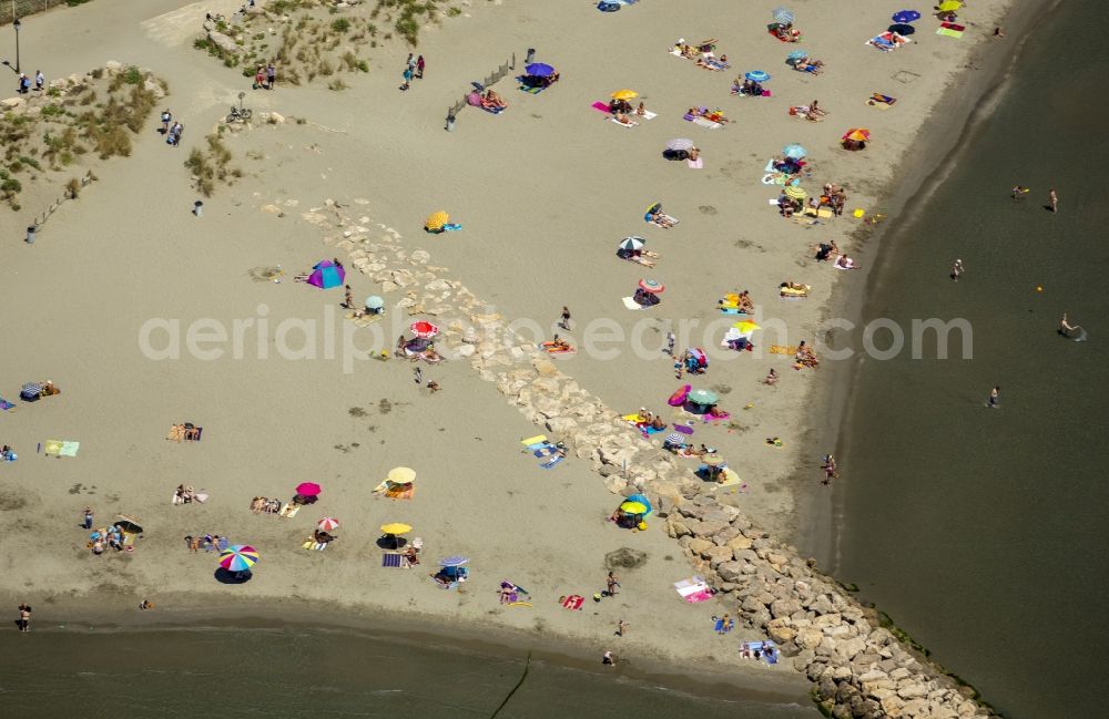 Saintes-Maries-de-la-Mer from above - Visitors and tourists on Mediterranean sandy beach in Saintes-Maries-de-la-Mer, Provence-Alpes-Cote d'Azur in France