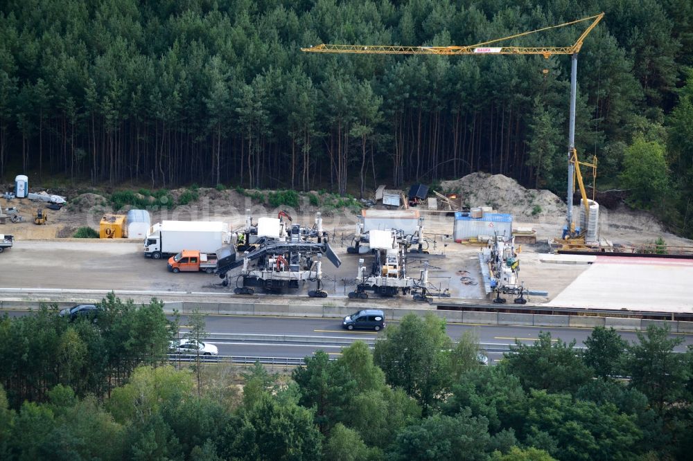 Aerial photograph Friedersdorf - View expansion and widening of the route of the highway / motorway BAB A12 / E30 Markgrafpieske in the state of Brandenburg. The picture shows a concrete paver contractorBickhardt Bau in the production of the new road surface