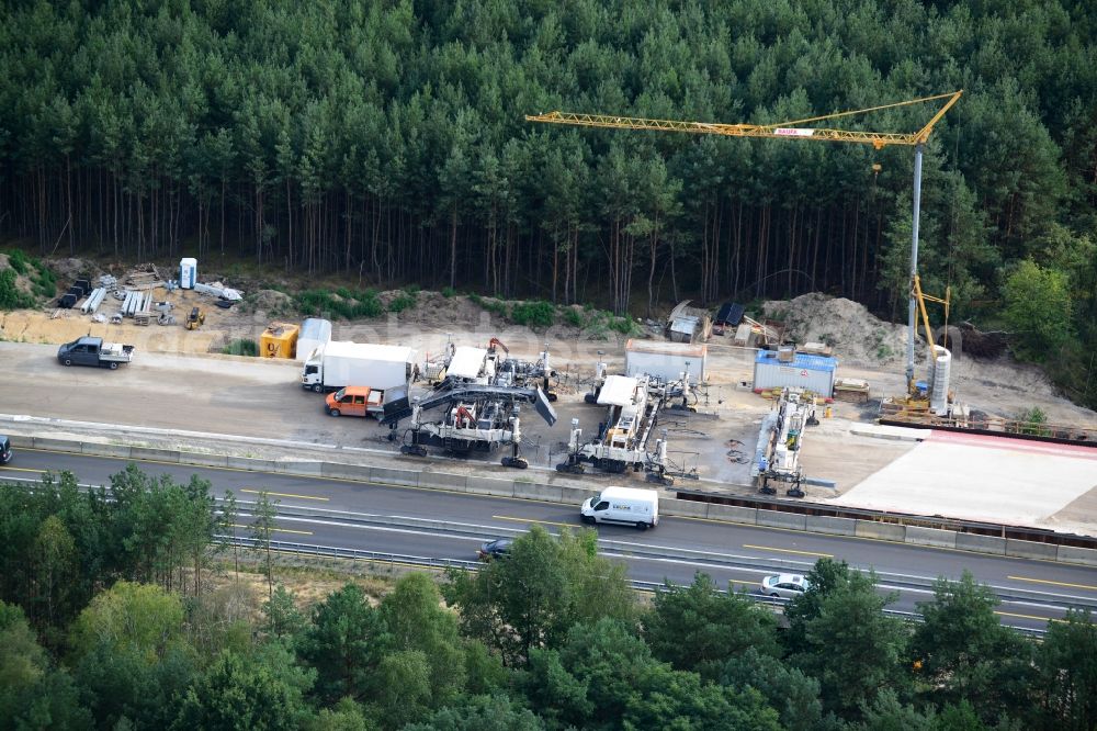 Friedersdorf from above - View expansion and widening of the route of the highway / motorway BAB A12 / E30 Markgrafpieske in the state of Brandenburg. The picture shows a concrete paver contractorBickhardt Bau in the production of the new road surface