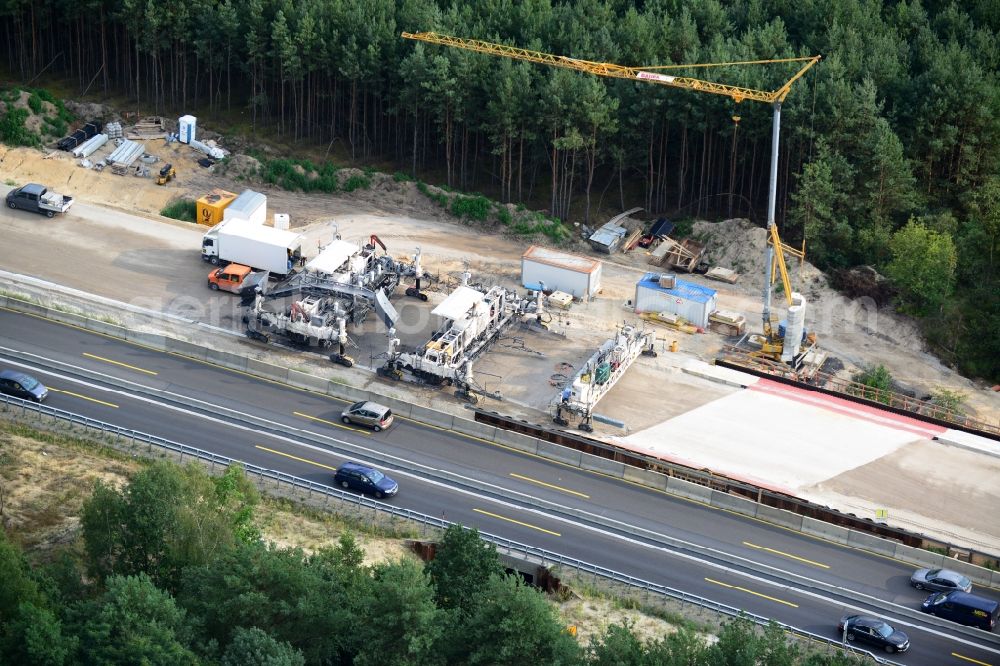 Friedersdorf from the bird's eye view: View expansion and widening of the route of the highway / motorway BAB A12 / E30 Markgrafpieske in the state of Brandenburg. The picture shows a concrete paver contractorBickhardt Bau in the production of the new road surface