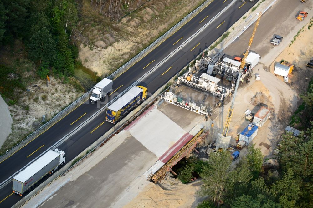 Friedersdorf from the bird's eye view: View expansion and widening of the route of the highway / motorway BAB A12 / E30 Markgrafpieske in the state of Brandenburg. The picture shows a concrete paver contractorBickhardt Bau in the production of the new road surface