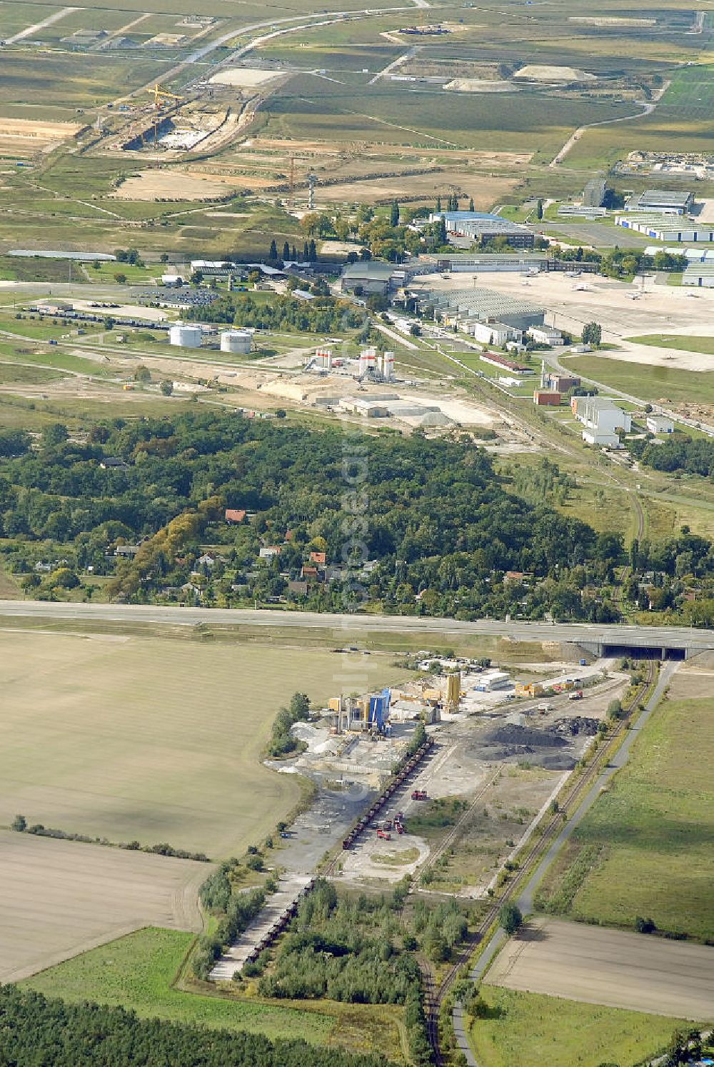 Aerial image Schönefeld - Blick auf das Betonwerk am Flughafen Schönefeld (BBI). Das eigens für den Bau des BBI Flughafens errichtete Betonwerk kann Beton, für bis zu 1000 LKW- Ladungen pro Tag, erzeugen. Look at the concrete plant at the Airport Schönefeld (BBI). The specially for the construction of the BBI airport built concrete plant, produce concrete for up to 1,000 truckloads per day.