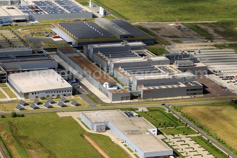 Arnstadt from above - The headquarters of Bosch Solar Energy is located at Luetzer field in Arnstadt in Thuringia. In the commercial area to the Robert-Bosch-Strasse crystalline and thin-film solar modules are produced. The company products are installed on the roofs of the production halls and the environment. In the production hall in the foreground the company Sauels ham GmbH & Co.KG has its headquarters