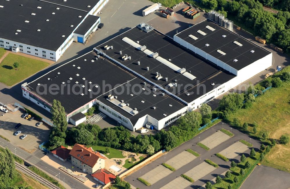 Ohrdruf from the bird's eye view: In the Herrenhoefer Landstrasse from Ohrdruf in Thuringia is the MKT Modern plastics technology Gebr.Eschbach. In the production halls of MKT decorative edging for furniture industry are made