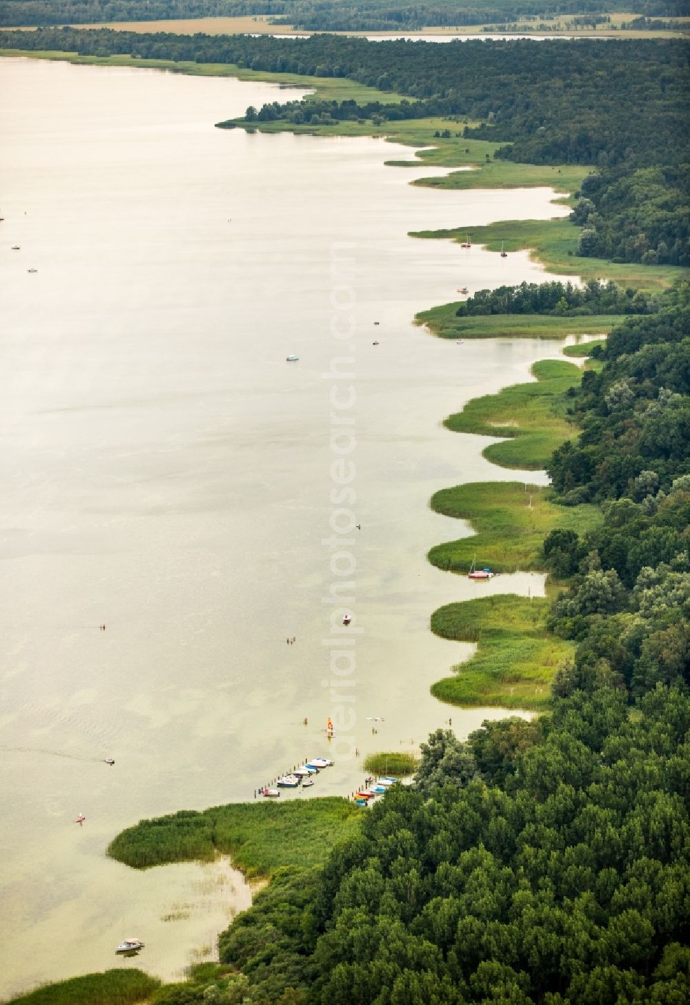 Boek from above - Wooded riparian areas of the Mueritz with small boats in Boek in the state of Mecklenburg - Western Pomerania