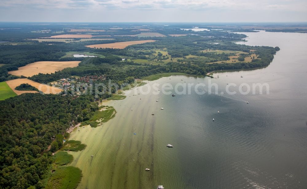 Aerial image Boeker Mühle - Wooded riparian areas of the Mueritz with small boats in Boeker Muehle in the state of Mecklenburg - Western Pomerania