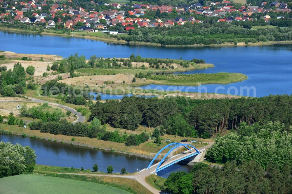 Aerial image Burg (bei Magdeburg) - Blue bridge over the Elbe-Havel-Kanal at the gravel pit of Niegripp in the West of the town of Burg (bei Magdeburg) in the state of Saxony-Anhalt. The distinct blue arc bridge spans the canal in the West of the town. The bridge is surrounded by forest and is one of several bridges on the canal. The background shows Niegripp