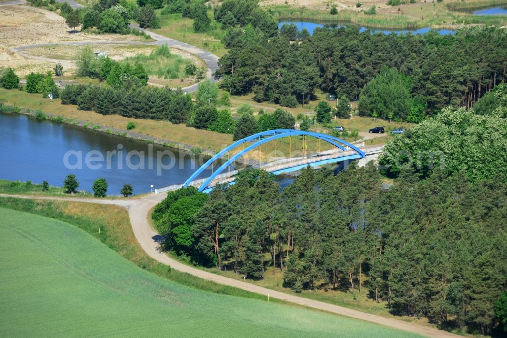 Burg (bei Magdeburg) from above - Blue bridge over the Elbe-Havel-Kanal at the gravel pit of Niegripp in the West of the town of Burg (bei Magdeburg) in the state of Saxony-Anhalt. The distinct blue arc bridge spans the canal in the West of the town. The bridge is surrounded by forest and is one of several bridges on the canal