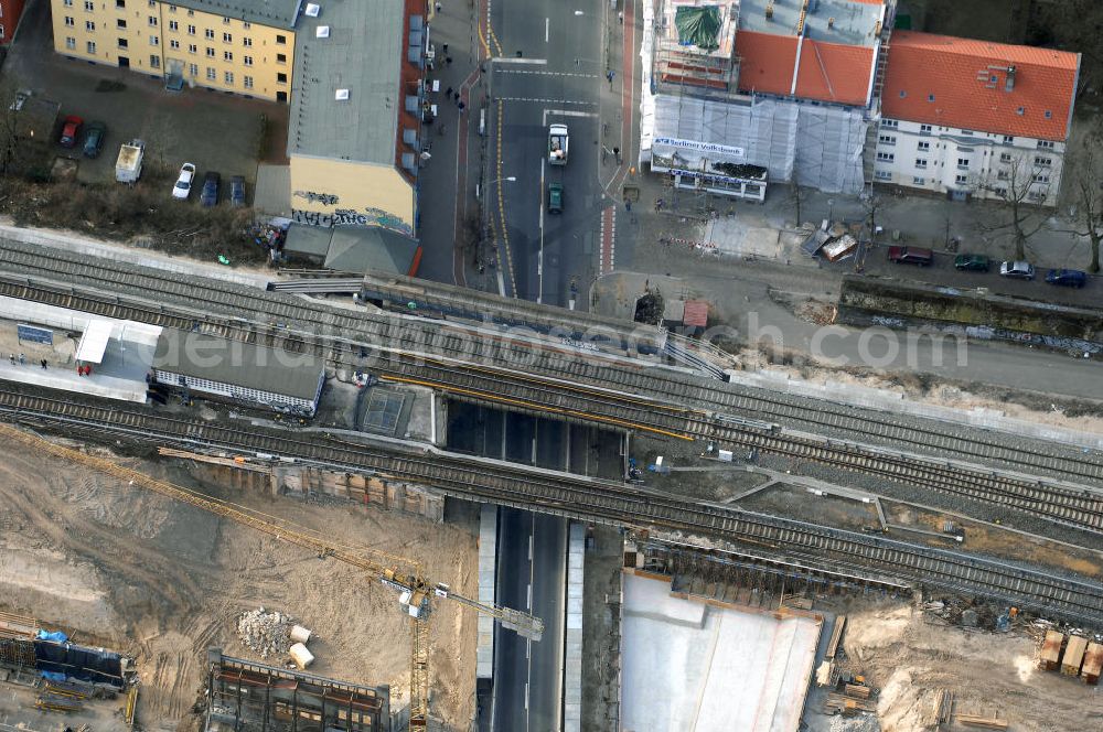 Aerial image Berlin - Blick auf den Um- und Ausbau des S-Bahnhofes Berlin-Baumschulenweg.Die Fassade des Haupteinganges auf der Ostseite, die der Bahnhof 1916 erhielt und die heute unter Denkmalschutz steht, bleibt dabei erhalten. Ansonsten wird der erneuerungsbedürftige Bahnhof künftig modernen Ansprüchen an Komfort, Sicherheit, Gestaltung und Leistungsfähigkeit gerecht. Rund 28 Millionen Euro werden investiert.Die Brücken der drei S-Bahn- und zwei Fernbahngleise werden neu gebaut. Die Breite der Baumschulenstraße bleibt erhalten, ebenso die auf 3,80 Meter beschränkte Durchfahrtshöhe.Die S-Bahnsteige werden neu gebaut und beide liegen künftig fast mittig über der Baumschulenstraße. Auch nach dem Umbau wird es drei S-Bahngleise mit einem Seitenbahnsteig für die Züge Richtung Stadt und einem Inselbahnsteig für die Züge Richtung Schöneweide geben. Ausführende Baufirma ist die EUROVIA Infra GmbH.