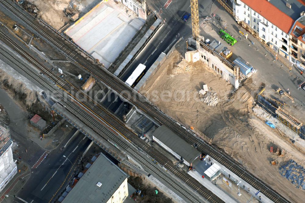 Aerial image Berlin - Blick auf den Um- und Ausbau des S-Bahnhofes Berlin-Baumschulenweg.Die Fassade des Haupteinganges auf der Ostseite, die der Bahnhof 1916 erhielt und die heute unter Denkmalschutz steht, bleibt dabei erhalten. Ansonsten wird der erneuerungsbedürftige Bahnhof künftig modernen Ansprüchen an Komfort, Sicherheit, Gestaltung und Leistungsfähigkeit gerecht. Rund 28 Millionen Euro werden investiert.Die Brücken der drei S-Bahn- und zwei Fernbahngleise werden neu gebaut. Die Breite der Baumschulenstraße bleibt erhalten, ebenso die auf 3,80 Meter beschränkte Durchfahrtshöhe.Die S-Bahnsteige werden neu gebaut und beide liegen künftig fast mittig über der Baumschulenstraße. Auch nach dem Umbau wird es drei S-Bahngleise mit einem Seitenbahnsteig für die Züge Richtung Stadt und einem Inselbahnsteig für die Züge Richtung Schöneweide geben. Ausführende Baufirma ist die EUROVIA Infra GmbH.