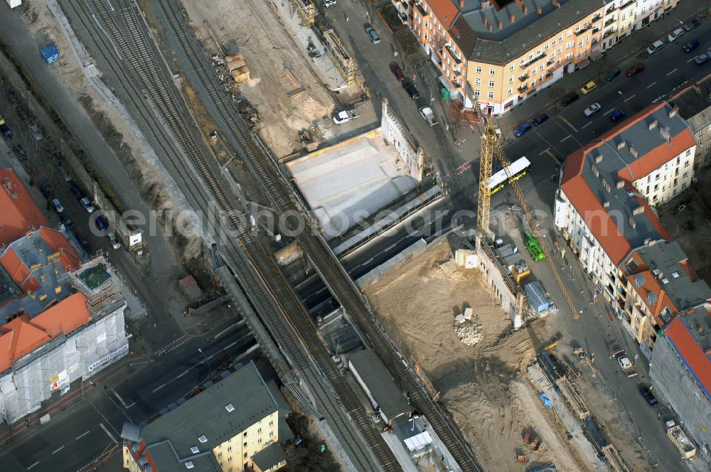 Berlin from the bird's eye view: Blick auf den Um- und Ausbau des S-Bahnhofes Berlin-Baumschulenweg.Die Fassade des Haupteinganges auf der Ostseite, die der Bahnhof 1916 erhielt und die heute unter Denkmalschutz steht, bleibt dabei erhalten. Ansonsten wird der erneuerungsbedürftige Bahnhof künftig modernen Ansprüchen an Komfort, Sicherheit, Gestaltung und Leistungsfähigkeit gerecht. Rund 28 Millionen Euro werden investiert.Die Brücken der drei S-Bahn- und zwei Fernbahngleise werden neu gebaut. Die Breite der Baumschulenstraße bleibt erhalten, ebenso die auf 3,80 Meter beschränkte Durchfahrtshöhe.Die S-Bahnsteige werden neu gebaut und beide liegen künftig fast mittig über der Baumschulenstraße. Auch nach dem Umbau wird es drei S-Bahngleise mit einem Seitenbahnsteig für die Züge Richtung Stadt und einem Inselbahnsteig für die Züge Richtung Schöneweide geben. Ausführende Baufirma ist die EUROVIA Infra GmbH.