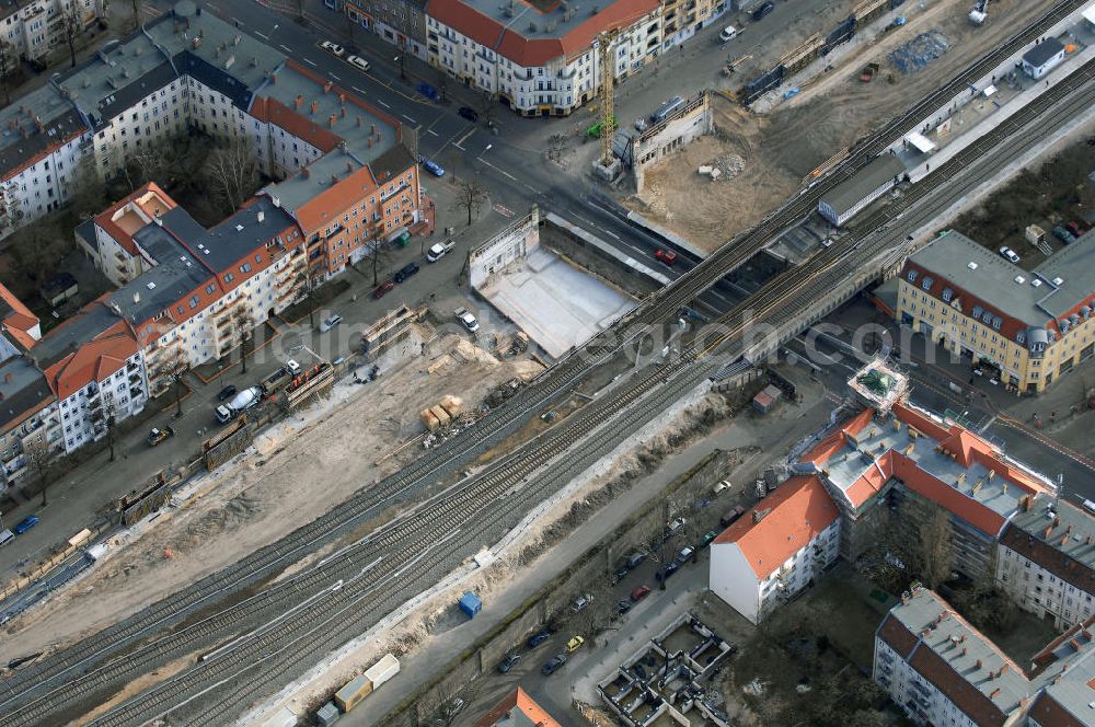 Berlin from the bird's eye view: Blick auf den Um- und Ausbau des S-Bahnhofes Berlin-Baumschulenweg.Die Fassade des Haupteinganges auf der Ostseite, die der Bahnhof 1916 erhielt und die heute unter Denkmalschutz steht, bleibt dabei erhalten. Ansonsten wird der erneuerungsbedürftige Bahnhof künftig modernen Ansprüchen an Komfort, Sicherheit, Gestaltung und Leistungsfähigkeit gerecht. Rund 28 Millionen Euro werden investiert.Die Brücken der drei S-Bahn- und zwei Fernbahngleise werden neu gebaut. Die Breite der Baumschulenstraße bleibt erhalten, ebenso die auf 3,80 Meter beschränkte Durchfahrtshöhe.Die S-Bahnsteige werden neu gebaut und beide liegen künftig fast mittig über der Baumschulenstraße. Auch nach dem Umbau wird es drei S-Bahngleise mit einem Seitenbahnsteig für die Züge Richtung Stadt und einem Inselbahnsteig für die Züge Richtung Schöneweide geben. Ausführende Baufirma ist die EUROVIA Infra GmbH.