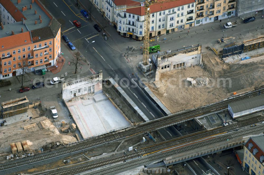 Aerial photograph Berlin - Blick auf den Um- und Ausbau des S-Bahnhofes Berlin-Baumschulenweg.Die Fassade des Haupteinganges auf der Ostseite, die der Bahnhof 1916 erhielt und die heute unter Denkmalschutz steht, bleibt dabei erhalten. Ansonsten wird der erneuerungsbedürftige Bahnhof künftig modernen Ansprüchen an Komfort, Sicherheit, Gestaltung und Leistungsfähigkeit gerecht. Rund 28 Millionen Euro werden investiert.Die Brücken der drei S-Bahn- und zwei Fernbahngleise werden neu gebaut. Die Breite der Baumschulenstraße bleibt erhalten, ebenso die auf 3,80 Meter beschränkte Durchfahrtshöhe.Die S-Bahnsteige werden neu gebaut und beide liegen künftig fast mittig über der Baumschulenstraße. Auch nach dem Umbau wird es drei S-Bahngleise mit einem Seitenbahnsteig für die Züge Richtung Stadt und einem Inselbahnsteig für die Züge Richtung Schöneweide geben. Ausführende Baufirma ist die EUROVIA Infra GmbH.