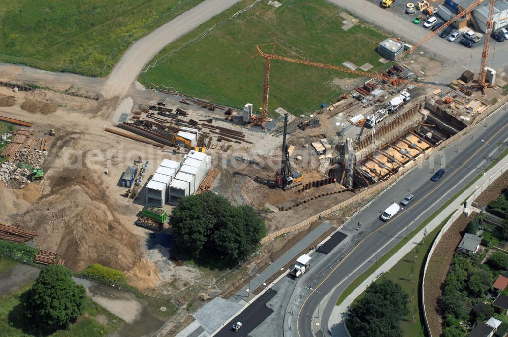 Aerial image Dresden - Blick auf die im Bau befindliche Waldschlösschenbrücke in Dresden. Das Bauvorhaben ist sehr umstritten, da die UNESCO bereits angedroht hat Dresden den Titel des Weltkulturerbes abzuerkennen, sollte der Bau der Brücke weitergeführt werden. Das Bautzner Oberverwaltungsgericht ordnete hingegen an die Brücke zu bauen, obwohl unklar ist ob dieses Vorhaben rechtens ist. Inzwischen wurden in der Planung der Brücke einige Änderungen vorgenommen. Der Bogen wird kleiner werden, die neue Planung sieht die Brücke einen Meter schmaler vor und die Füße werden nicht so wuchtig, sondern dezent ausfallen. Kontakt: Landeshauptstadt Dresden Stadtplanungsamt Abteilung Stadtplanung und Stadtgestaltung Frau Tauber, Postfach 120020 01001 Dresden, Technisches Rathaus, Hamburger Straße 19 01067 Dresden, 2. Etage, Zimmer 2042, Tel. +49(0)351 4883577, Fax +49(0)351 4883456, Email: bauleitplanung-altstadt-blasewitz@dresden.de; AWB Architekten Architekturbüro Bauer BDA, Blasewitzer Straße 78 01307 Dresden, Tel. +49(0)351 49709 0, Fax +49(0)351 49709 20