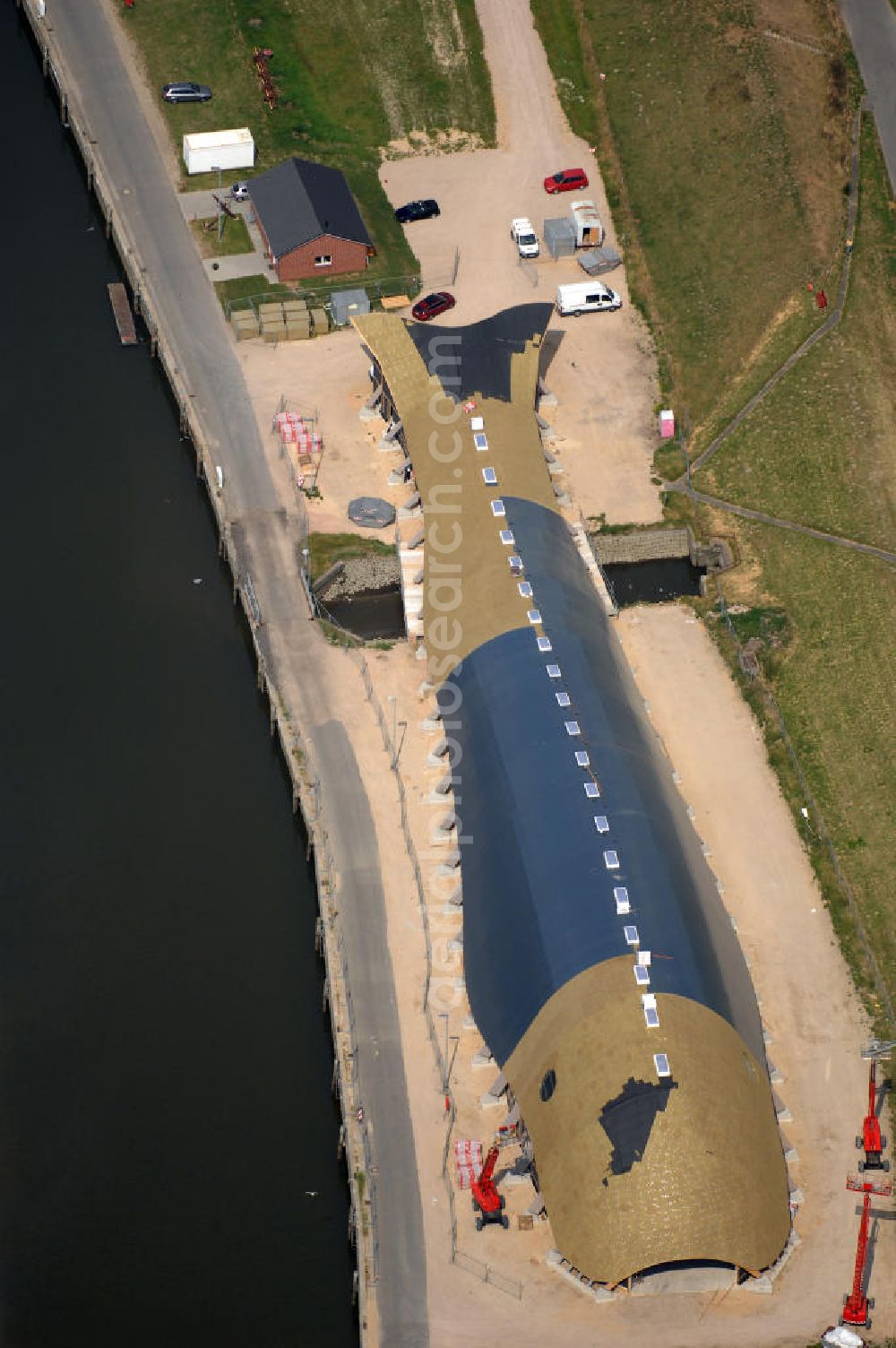 Aerial photograph Friedrichskoog - Blick auf eine Baustelle für eine Indoor - Spielhalle in Friedrichskoog. DIe Freizeit - Spielhalle in Form eines Wals kostet 3 Mio. Euro. Richtfest war im Mai 2008. Architekt: rimpf Architektur, Rosengang 4, 24340 Eckernförde, Tel. +49 (0)4351 7172 0, Fax +49 (0)4351 7172 73, Email info@rimpf.de