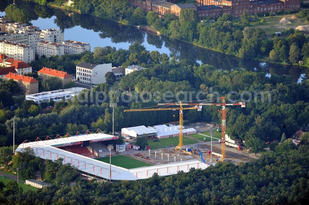 Berlin from the bird's eye view: View of the construction site at the stadium An der Alten Förste in Berlin. The football stadium in Köpenick in the district of Treptow-Koepenick was opened in 1920 and has served as the home stadium of the 1st FC Union Berlin. In May 2012 the old main stand was demolished and a new building began. It should be built a new grandstand with 3,700 seats and 38 boxes, and new parking spaces for a total of 17 million €. The costs are borne by the State of Berlin, by the association and by debts