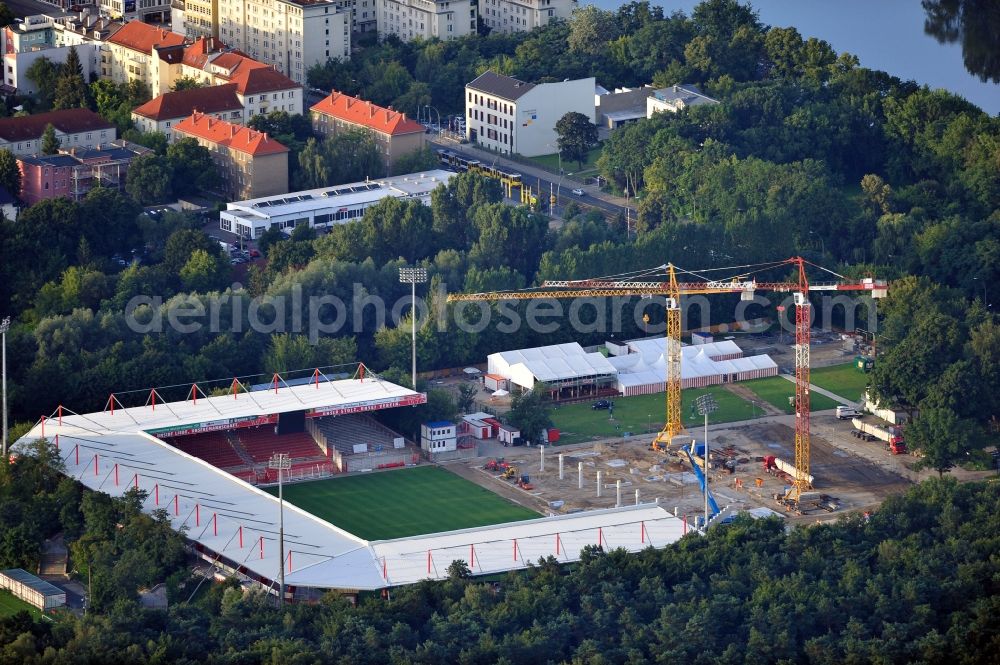 Aerial photograph Berlin - View of the construction site at the stadium An der Alten Förste in Berlin. The football stadium in Köpenick in the district of Treptow-Koepenick was opened in 1920 and has served as the home stadium of the 1st FC Union Berlin. In May 2012 the old main stand was demolished and a new building began. It should be built a new grandstand with 3,700 seats and 38 boxes, and new parking spaces for a total of 17 million €. The costs are borne by the State of Berlin, by the association and by debts