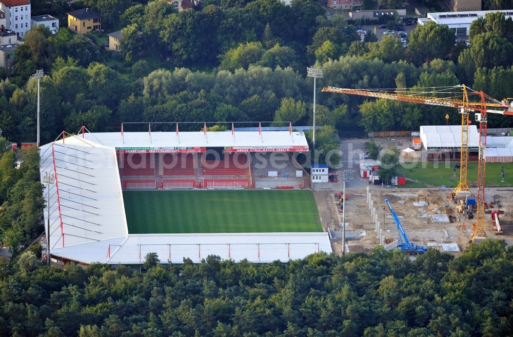 Berlin from above - View of the construction site at the stadium An der Alten Förste in Berlin. The football stadium in Köpenick in the district of Treptow-Koepenick was opened in 1920 and has served as the home stadium of the 1st FC Union Berlin. In May 2012 the old main stand was demolished and a new building began. It should be built a new grandstand with 3,700 seats and 38 boxes, and new parking spaces for a total of 17 million €. The costs are borne by the State of Berlin, by the association and by debts