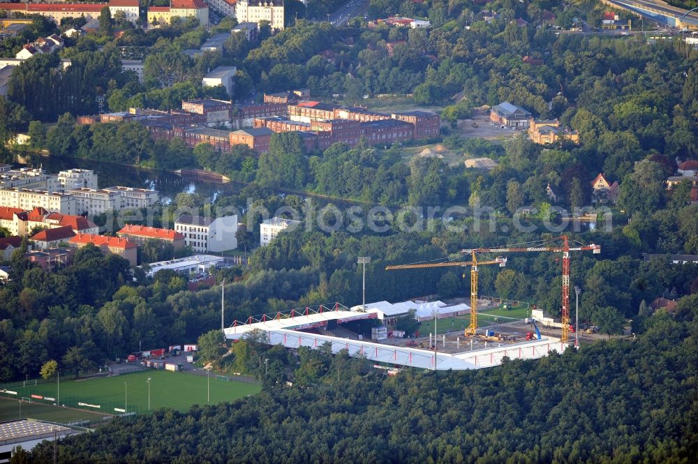 Berlin from the bird's eye view: View of the construction site at the stadium An der Alten Förste in Berlin. The football stadium in Köpenick in the district of Treptow-Koepenick was opened in 1920 and has served as the home stadium of the 1st FC Union Berlin. In May 2012 the old main stand was demolished and a new building began. It should be built a new grandstand with 3,700 seats and 38 boxes, and new parking spaces for a total of 17 million €. The costs are borne by the State of Berlin, by the association and by debts