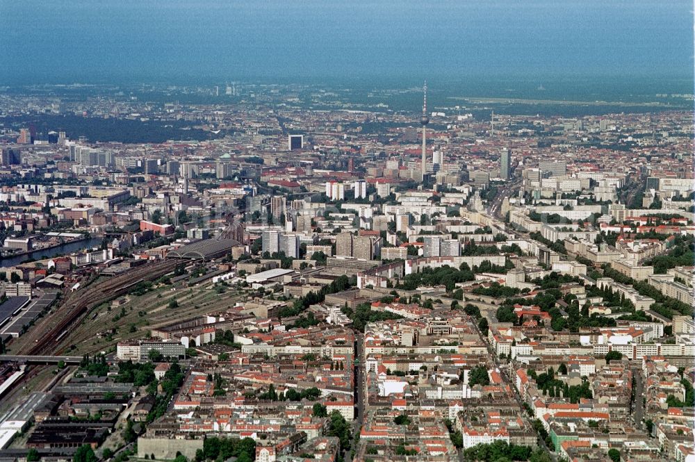 Berlin from the bird's eye view: View of Berlin from Berlin-Friedrichshain Berlin City East direction. In the center of the image of the TV tower is a landmark of the capital. Good to see the arched halls of the Eastern Railway Station and the striking high-rise building of the International Trade Centre at Friedrichstrasse