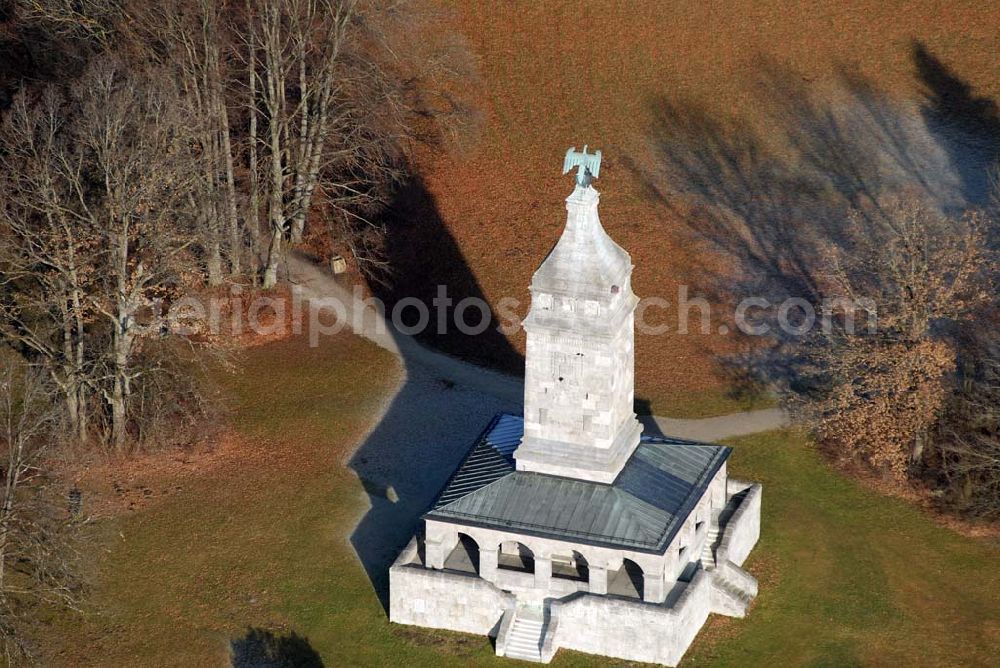 Assenhausen from above - Blick auf den Bismarckturm in Assenhausen am Starnberger See. Im Jahre 1890 wurde in München unter dem Vorsitz des Malers Prof. Dr. Franz von Lenbach und Bürgermeister Dr. von Widenmayer ein Komitee zur Errichtung einer Bismarcksäule gegründet. Die Einweihung des 30 m hohen Ehrenturmes fand am 01.07.1899 statt. Der Bismarck-Verein schenkte das Denkmal (mit 9,172 Hektar großem Grundstück) der Stadt München. Um den quadratischen Sockel des Turmes läuft eine mit 16 offenen Rundbögen gebildete Wandelhalle. Von allen vier Seiten führen Treppen zur Wandelhalle. In der Halle sind Wappenschilde der Bundesstaaten und freien Städte, an der Nordseite eine Bismarck-Widmungstafel mit den Portraitköpfen Karls des Großen, Friedrich Barbarossas, Ottos des Großen, Goethes, Dürers und Beethovens (Vorbilder Bismarcks) angebracht. Der Turm ist bekrönt von einem kupfernen Adler (hergestellt von Kiehne). Als Material für den Turm wurden Kalkstein und Tuff verwendet. Die künstlerische Gestaltung (außen und innen) oblag den Bildhauern H. Flossmann und Georg Wrba. Die Bronzetafel mit Bismarckwappen und Reichsadlerrelief (s. Foto oben mitte) wurde von der Erzgießerei Renaissance (Johann Lampel) hergestellt.