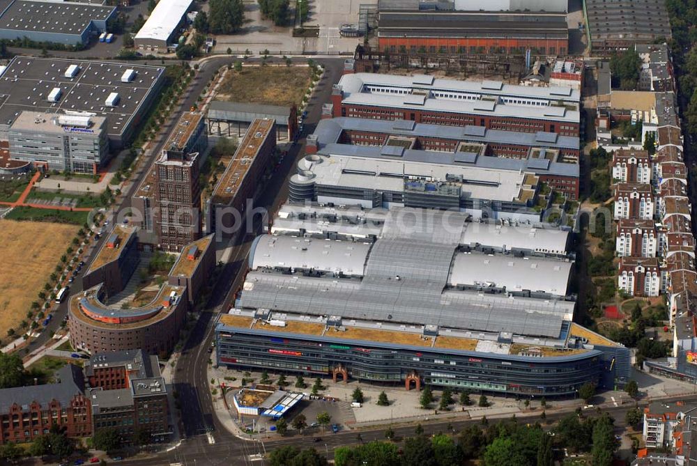 Aerial image Berlin - Blick auf die Borsig-Hallen in Berlin-Tegel. Das ehemalige Lokomotivenwerk des Borsig-Unternehmens wurde 1898 eingeweiht. Bis 1930 wurden hier Lokomotiven, Dampfmaschinen u.a. hergestellt. Um dem Bankrott zu entkommen, fusionierten die Firmen Borsig und Rheinmetall. Das Werk wurde 1938 zum Reichswerk Hermann Göring bis es im 2. WK fast zerstört wurde. 1988 ging das Werk an das Land Berlin über. Nun wurde es zum Einkaufszentrum Hallen am Borsigturm umgebaut.