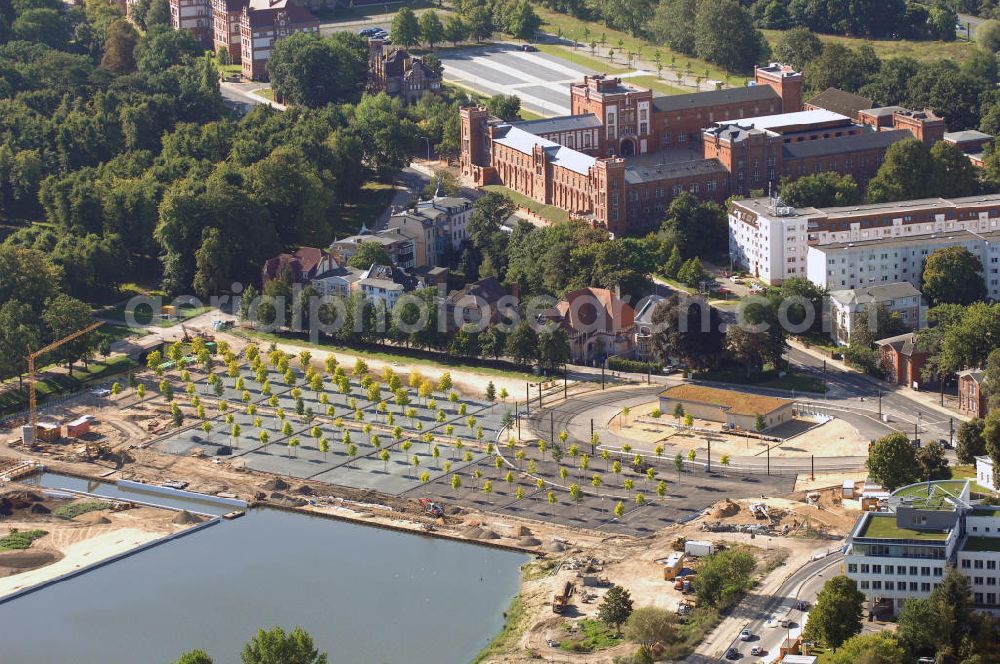 Aerial image Schwerin - Blick auf das BUGA 2009 - Gelände rund um den Schweriner See. Im Mittelpunkt der Bundesgartenschau, welche 2009 zum zweiten Mal in Mecklenburg-Vorpommern stattfindet, steht die geschichtliche Entwicklung der Gartenbaukunst. Die Ausstellungsareale sammeln sich kompakt um das Schweriner Schloss bzw. die Altstadt. Die insgesamt sieben Gärten, welche alle in Wassernähe liegen, werden durch eine Vielzahl von Umlandprojekten in ganz Mecklenburg-Vorpommern ergänzt. Die BUGA 2009 findet auf einer Gesamtfläche von 550.000 qm statt und kostet 72,2 Mio. Euro. Kontakt: Bundesgartenschau Schwerin 2009 GmbH, Eckdrift 43 - 45, 19061 Schwerin, Tel. +49 (0)385 2009 0, Fax +49 (0)385 2009 111, EMail info@buga-2009.de