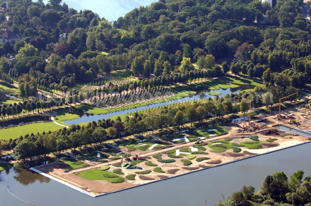 Aerial photograph Schwerin - Blick auf das BUGA 2009 - Gelände rund um den Schweriner See. Im Mittelpunkt der Bundesgartenschau, welche 2009 zum zweiten Mal in Mecklenburg-Vorpommern stattfindet, steht die geschichtliche Entwicklung der Gartenbaukunst. Die Ausstellungsareale sammeln sich kompakt um das Schweriner Schloss bzw. die Altstadt. Die insgesamt sieben Gärten, welche alle in Wassernähe liegen, werden durch eine Vielzahl von Umlandprojekten in ganz Mecklenburg-Vorpommern ergänzt. Die BUGA 2009 findet auf einer Gesamtfläche von 550.000 qm statt und kostet 72,2 Mio. Euro. Kontakt: Bundesgartenschau Schwerin 2009 GmbH, Eckdrift 43 - 45, 19061 Schwerin, Tel. +49 (0)385 2009 0, Fax +49 (0)385 2009 111, EMail info@buga-2009.de