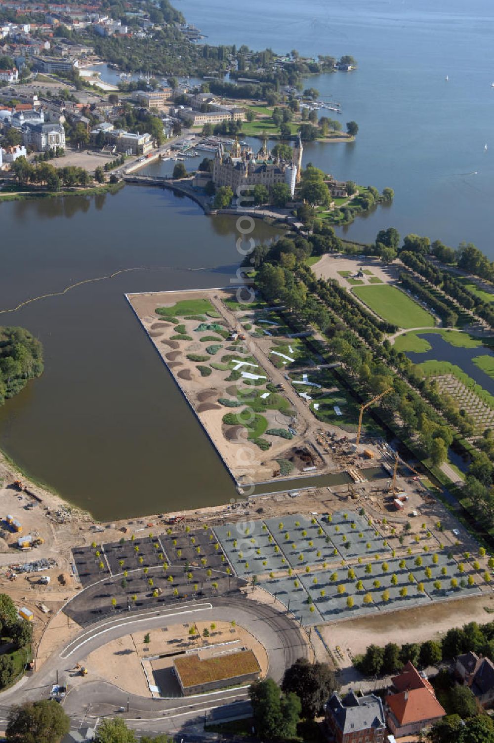 Schwerin from the bird's eye view: Blick auf das BUGA 2009 - Gelände rund um den Schweriner See. Im Mittelpunkt der Bundesgartenschau, welche 2009 zum zweiten Mal in Mecklenburg-Vorpommern stattfindet, steht die geschichtliche Entwicklung der Gartenbaukunst. Die Ausstellungsareale sammeln sich kompakt um das Schweriner Schloss bzw. die Altstadt. Die insgesamt sieben Gärten, welche alle in Wassernähe liegen, werden durch eine Vielzahl von Umlandprojekten in ganz Mecklenburg-Vorpommern ergänzt. Die BUGA 2009 findet auf einer Gesamtfläche von 550.000 qm statt und kostet 72,2 Mio. Euro. Kontakt: Bundesgartenschau Schwerin 2009 GmbH, Eckdrift 43 - 45, 19061 Schwerin, Tel. +49 (0)385 2009 0, Fax +49 (0)385 2009 111, EMail info@buga-2009.de