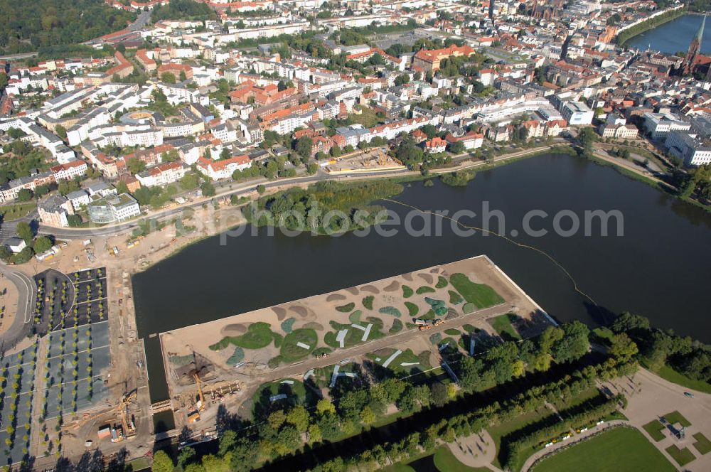 Aerial image Schwerin - Blick auf das BUGA 2009 - Gelände rund um den Schweriner See. Im Mittelpunkt der Bundesgartenschau, welche 2009 zum zweiten Mal in Mecklenburg-Vorpommern stattfindet, steht die geschichtliche Entwicklung der Gartenbaukunst. Die Ausstellungsareale sammeln sich kompakt um das Schweriner Schloss bzw. die Altstadt. Die insgesamt sieben Gärten, welche alle in Wassernähe liegen, werden durch eine Vielzahl von Umlandprojekten in ganz Mecklenburg-Vorpommern ergänzt. Die BUGA 2009 findet auf einer Gesamtfläche von 550.000 qm statt und kostet 72,2 Mio. Euro. Kontakt: Bundesgartenschau Schwerin 2009 GmbH, Eckdrift 43 - 45, 19061 Schwerin, Tel. +49 (0)385 2009 0, Fax +49 (0)385 2009 111, EMail info@buga-2009.de