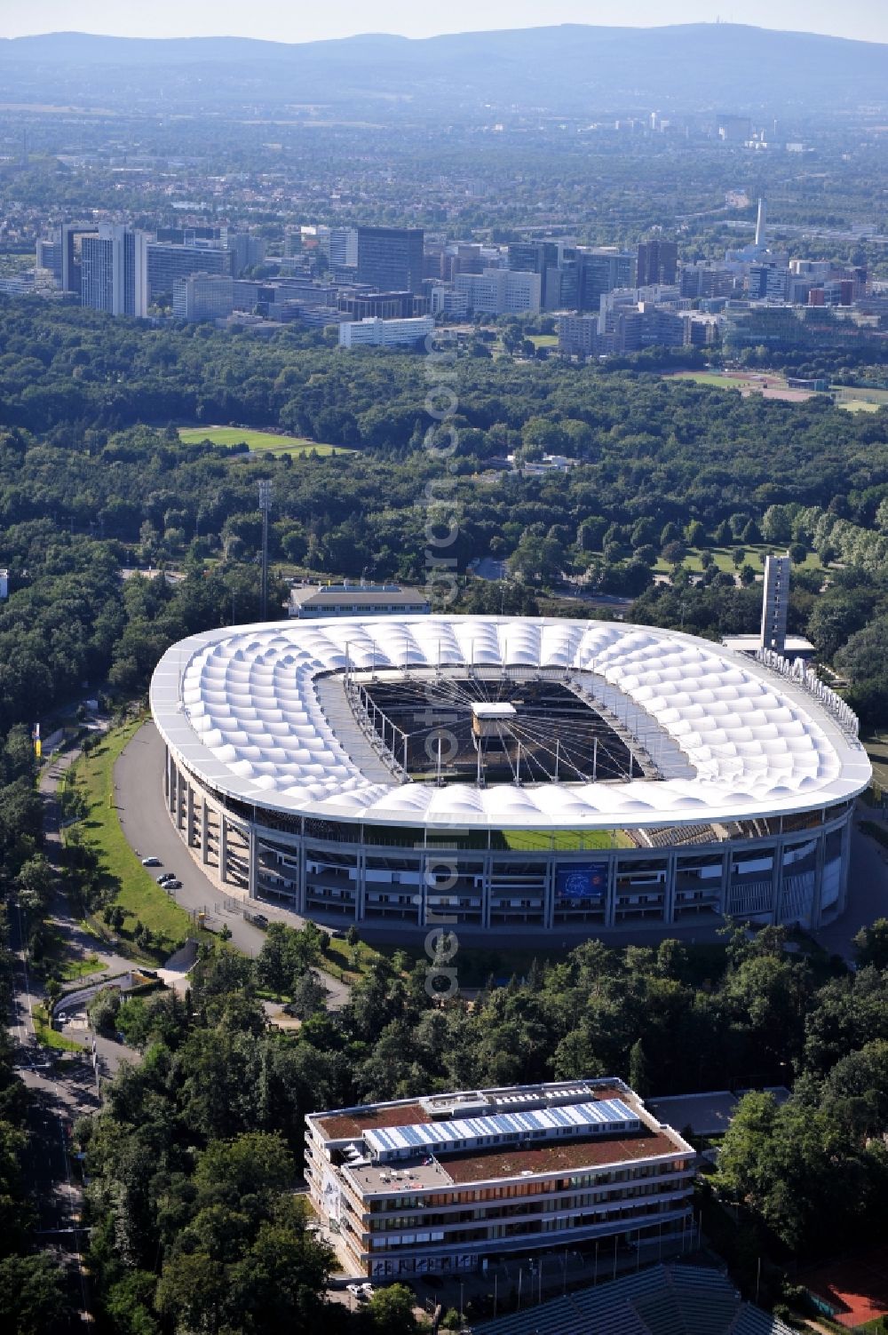 Aerial photograph Frankfurt am Main - View of the Commerzbank Arena in Frankfurt am Main. The arena, which is often called Walstadion, is located south of the river Main. The stadium, which opened in 1925 and has since then been repeatedly modernized, was on the occasion of the FIFA World Cup 2006 designed by the architectural firm Gerkan, Marg and Partners and built between 2002 and 2005 as a pure soccer stadium. With a capacity of 51,500 spectators, it is one of the ten largest soccer stadiums in Germany. The opening of the new stadium took place in June 2005