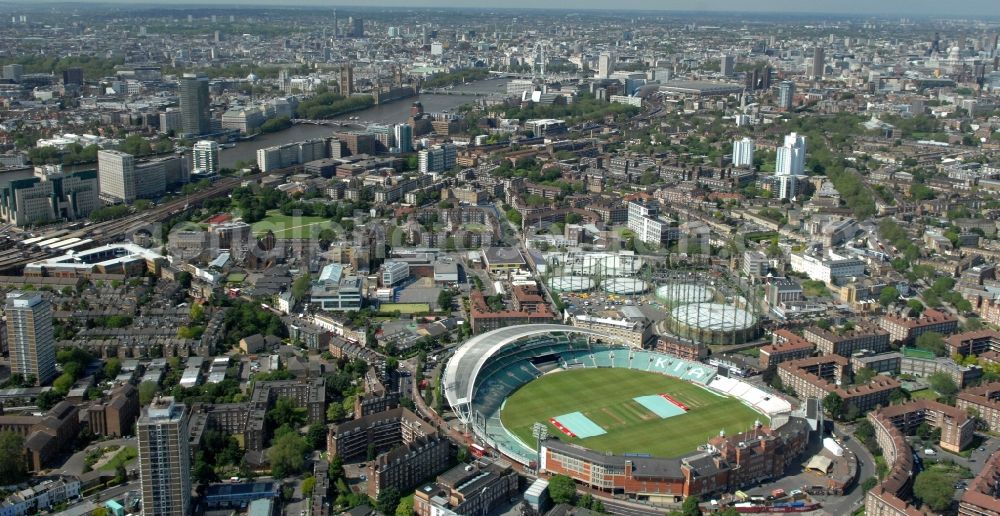 Aerial photograph London - View of the cricket stadium The Oval Cricket Ground in the suburb of Kennington, London. The stadium has been the home of Surrey County Cricket Club (SCCC) since 1845 and is sponsored by the company Kia. Behind the stadium, there are also gas tanks under monument protection