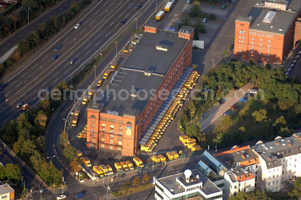 Aerial image Berlin - Blick auf eine Filiale der Post-Logistiktochter DHL in Berlin-Tempelhof an dem links verlaufenden Tempelhofer Damm. Die untere Straße ist die Schöneberger Straße, unter der das sich ebenfalls in dem Gebäude befindliche Fitnessstudio der McFit GmbH seine Anschrift hat. Kontakt: