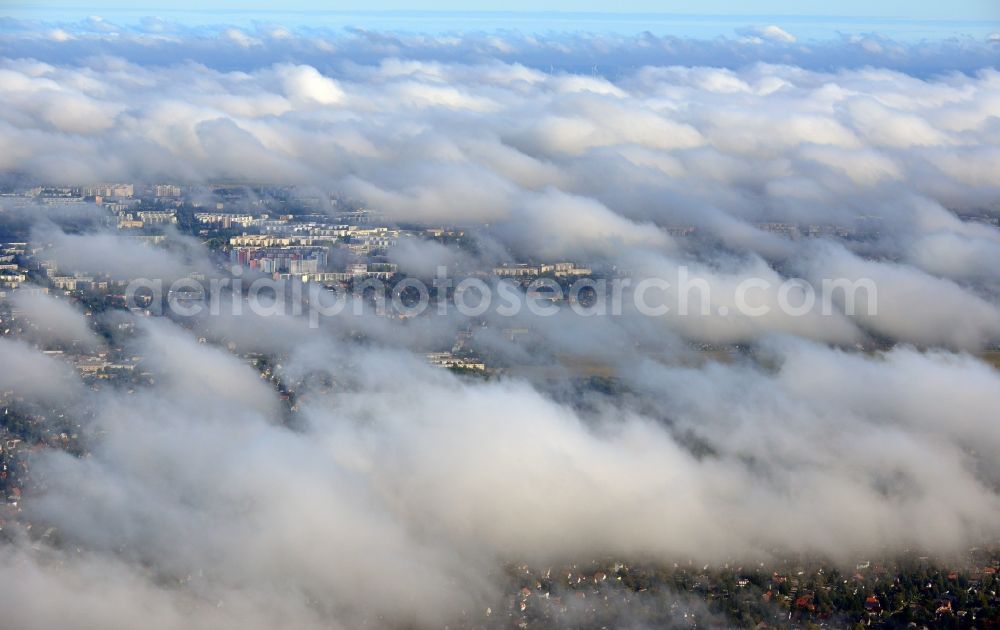 Aerial photograph Berlin - View through a thick cloud cover over residential areas and allot settlements in autumnal Berlin - Koepenick with a glimpse of highrises in the Marzahn-Hellersdorf district