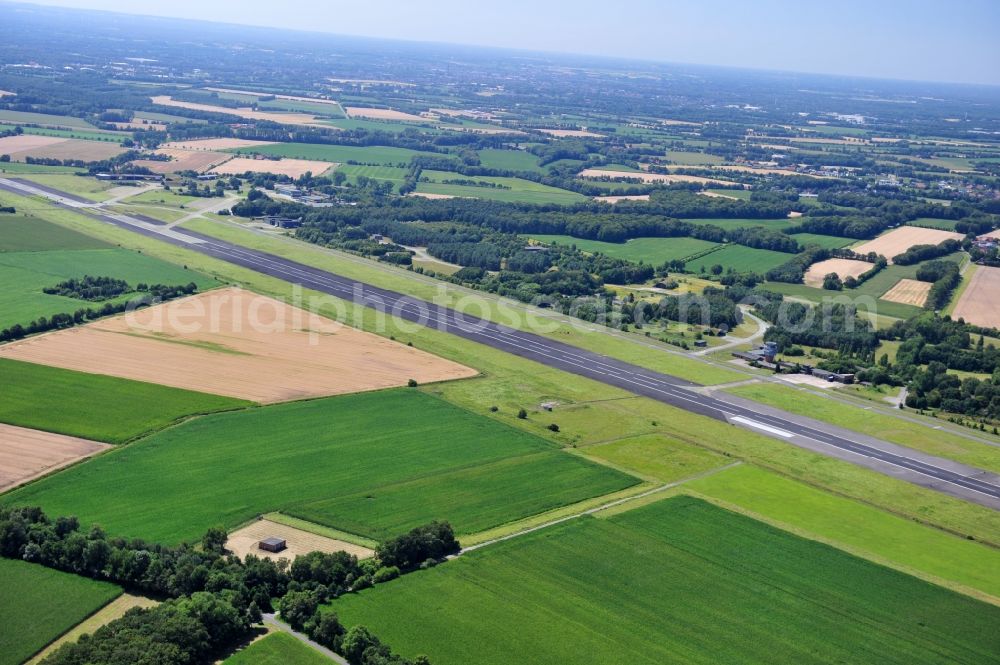 Hopsten from above - View of the former air base Hopsten near the homonymous place in North Rhine-Westphalia. The military airport for the German Air Force was opened in 1938. The Jagdgeschwader 72 Westfalen and the F-4F flight training center for the McDonnell F-4 Phantom II were stationed there until the operation was shut down in 2006. Currently, the start and runway is being used as storage space for the truck plane of the vehicle plant Krone