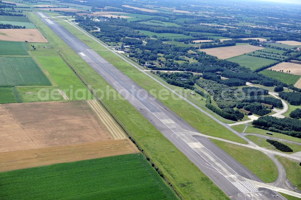 Aerial image Hopsten - View of the former air base Hopsten near the homonymous place in North Rhine-Westphalia. The military airport for the German Air Force was opened in 1938. The Jagdgeschwader 72 Westfalen and the F-4F flight training center for the McDonnell F-4 Phantom II were stationed there until the operation was shut down in 2006. Currently, the start and runway is being used as storage space for the truck plane of the vehicle plant Krone