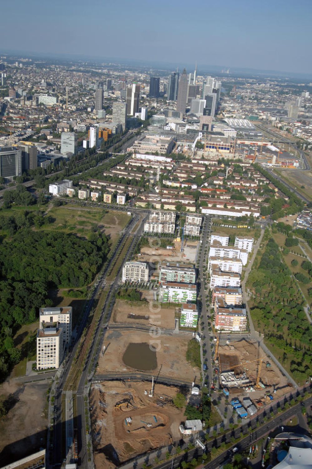 Frankfurt am Main from the bird's eye view: Blick entlang der Theodor-Heuss-Alle zur Frankfurter Innenstadt. Zu sehen sind Wohngebiete am Dammgraben, Geschäfts- und Industriebauten, sowie die Wolkenkratzer der City und Umgebung.