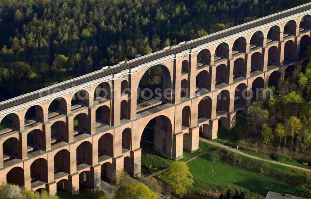 Aerial photograph Reichenbach (Sachsen) - Blick auf die Göltzschtalbrücke bei Reichenbach im ogtland. Der Viadukt wurde in den Jahren 1846 bis 1851 durch Prof. Johann Schubert und die Ingenieure Robert Wilke und Ferdinand Dost im Auftrag der Sächsisch-Bayrischen Eisenbahn erbaut. Er gilt bis heute als die größte Ziegelbrücke der Welt. Auch heute wird er rege genutzt und immer wieder neuen Gegebenheiten angepasst und technisch verbessert.