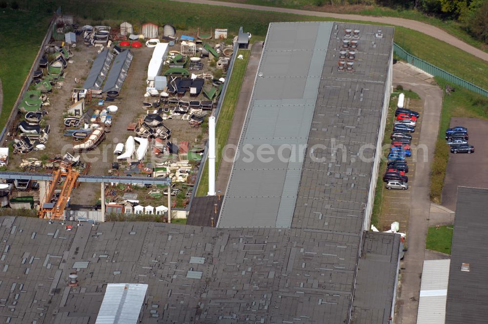 Aerial photograph Dessau - Blick auf das Industriegelände des ehemaligen VEB Waggonbau Dessau. Der VEB Waggonbau Dessau war einer der größten Hersteller von Schienenfahrzeug-Waggons in der ehemaligen DDR und einer der größten Hersteller von Kühlwaggons in der Welt. Am 24. Juli 1990 erfolgte die Eintragung als Waggonbau Dessau GmbH in das Handelsregister. Zum 1. Juli 1995 erfolgte die Schließung der Waggonbau Dessau GmbH. Als Nachfolgeeinrichtungen entstanden auf dem Gelände die Fahrzeugtechnik Dessau, die als Nachfolgeunternehmen ca. 200 Mitarbeiter übernahm, ein Industriepark sowie eine Qualifizierungsgesellschaft. Kontakt: FTD Fahrzeugtechnik Dessau AG i.I., 06844 Dessau-Roßlau, Am Waggonbau 11, Tel. +49 (0)340 25 370, Fax +49 (0)340 25 37105, EMail zentrale@fahrzeugtechnik-dessau.de