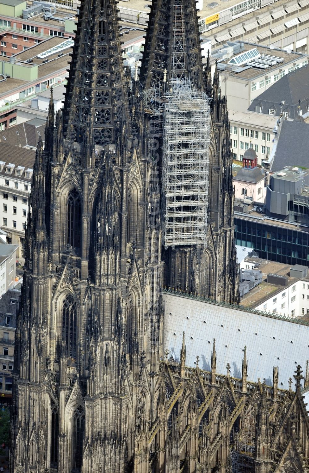 Köln from the bird's eye view: View of the Cologne Cathedral with scaffolding on the north tower.The the 157-meter high Gothic building, whose construction started in 1248 and was completed in 1880, belongs to the UNESCO World Heritage since 1996 and is redeveloped again and again. Currently, two frameworks are at the north tower of the cathedral, thus the stonemasons can expand the connecting elements of the sandstone, restore angel figurines and fix old war damage