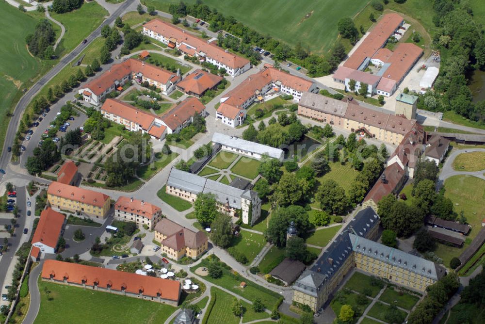 Aerial photograph Münnerstadt - Blick auf das Klostergelände Bildhausen in Münnerstadt. Das Kloster wurde 1158 durch Hermann von Stahleck, Pfalzgraf bei Rhein gegründet und von Mönchen aus dem Kloster Ebrach besiedelt. 1897 zogen Schwestern der St. Josefskongregation aus Ursberg ein und errichteten 1929 eine Behinderteneinrichtung. Diese wird seit 1996 von der kirchlichen Stiftung Dominikus-Ringeisen-Werk weitergeführt. Kontakt: Maria Bildhausen, 97702 Münnerstadt, Tel.: (09766) 94 00 5 - 0, Fax: (09766) 94 00 5 - 11, email: info@bildhausen.de