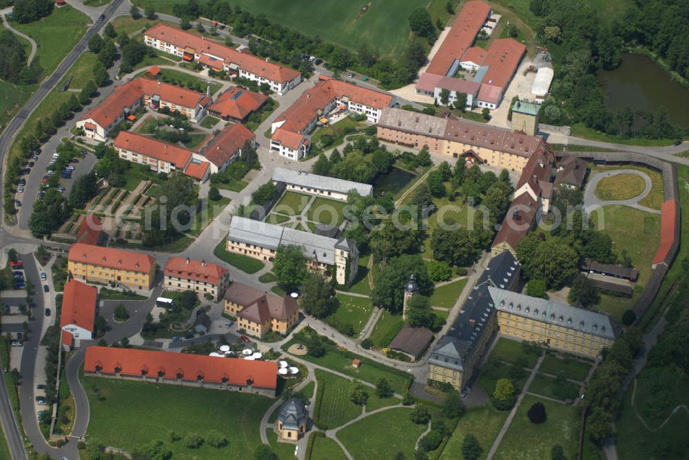 Münnerstadt from above - Blick auf das Klostergelände Bildhausen in Münnerstadt. Das Kloster wurde 1158 durch Hermann von Stahleck, Pfalzgraf bei Rhein gegründet und von Mönchen aus dem Kloster Ebrach besiedelt. 1897 zogen Schwestern der St. Josefskongregation aus Ursberg ein und errichteten 1929 eine Behinderteneinrichtung. Diese wird seit 1996 von der kirchlichen Stiftung Dominikus-Ringeisen-Werk weitergeführt. Kontakt: Maria Bildhausen, 97702 Münnerstadt, Tel.: (09766) 94 00 5 - 0, Fax: (09766) 94 00 5 - 11, email: info@bildhausen.de