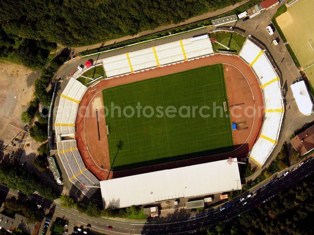 Siegen from above - 27.08.2005 Siegen; Seit dem letzten Umbau hat das Leimbachstadion ein Fassungsvermögen von ca. 18.500 Plätzen Zuschauern. Knapp 2.000 Sitzplätze befinden sich unter dem Dach der Haupttribüne, dazu auch noch weitere rund 1.200 Stehplätze. Seit zwei Jahren existiert ein modernisierter Gästeblock und auch die restlichen Stehstufen wurden mittlerweile komplett erneuert.