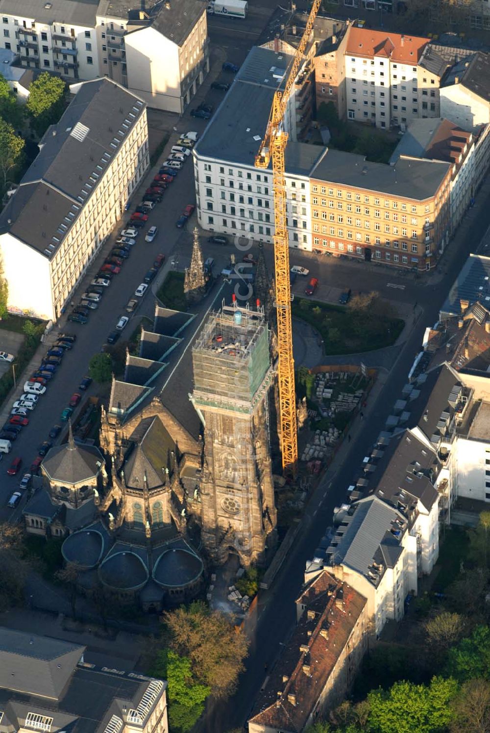 Aerial photograph Leipzig - Blick auf die Leipziger Peterskirche. 1885 wurde der neogotische Bau geweiht. Er wurde im 2. Weltkrieg stark beschädigt. Bis heute wurde er noch nicht vollständig rekonstruiert. Zur Zeit wird der Kirchturm restauriert. Kontakt: Ev.-luth. Kirchgemeinde St. Petri, Schletterstraße 5, 04107 Leipzig, Tel.: 0341 - 213 16 12, Fax: 0341 - 149 44 32, E-Mail: info@peterskirche-leipzig.de,