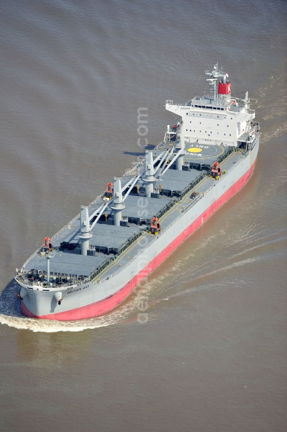 Aerial image Brokdorf - View of the bulk carrier Britain Bay on the Elbe near the town of Brokdorf in the state of Schleswig-Holstein. The cargo ship was built in 2012 by Kawasaki Sakaide Works and belongs to K Line Bulk Shipping Uk