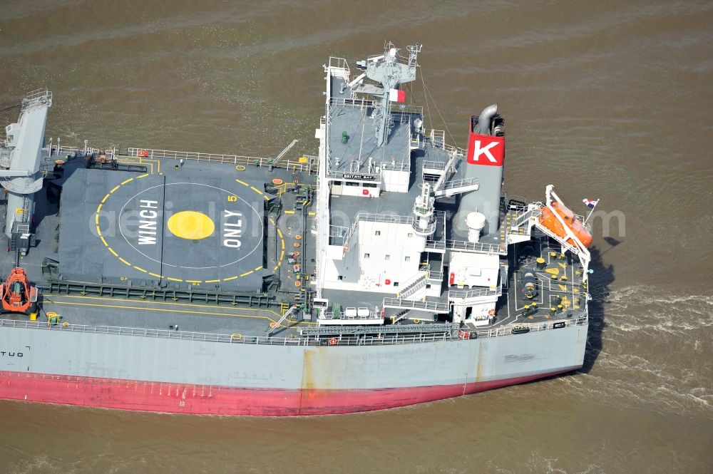 Brokdorf from the bird's eye view: View of the bulk carrier Britain Bay on the Elbe near the town of Brokdorf in the state of Schleswig-Holstein. The cargo ship was built in 2012 by Kawasaki Sakaide Works and belongs to K Line Bulk Shipping Uk